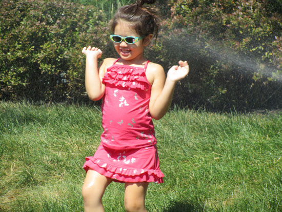 Playing in the sprinkler in the front yard