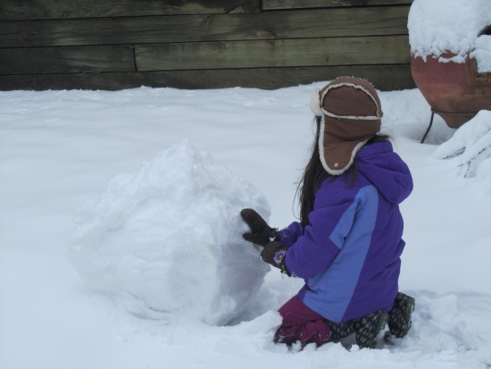 Rolling up a big snowball for the snowman