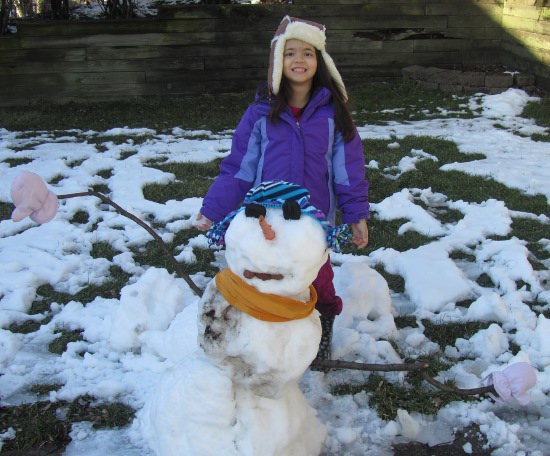 Yaya is so happy the snowman has clothes!