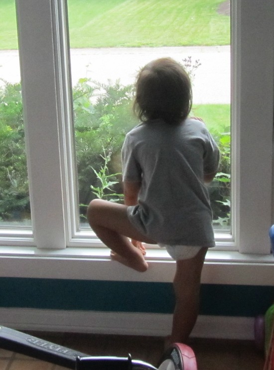 Looking out the window - macho, even though he has a diaper and no pants on?
