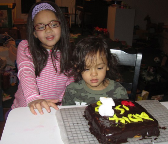 Both Yaya and Adik seem fascinated by the cake