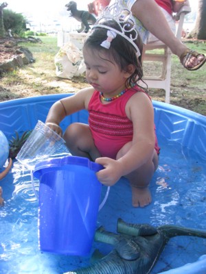 Buckets, dinosaurs and tiara-ed baby in the water
