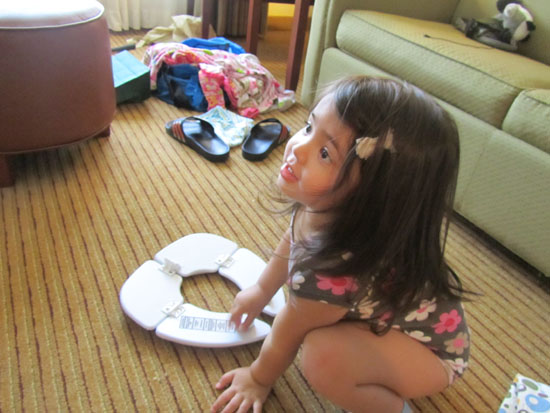 Playing with her potty seat