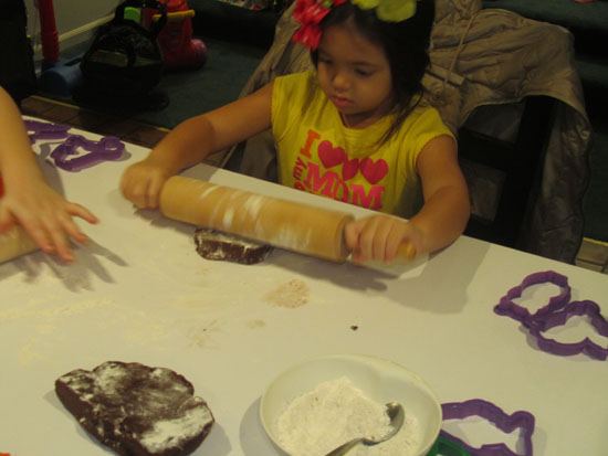 Yaya gives the rolling pin a try