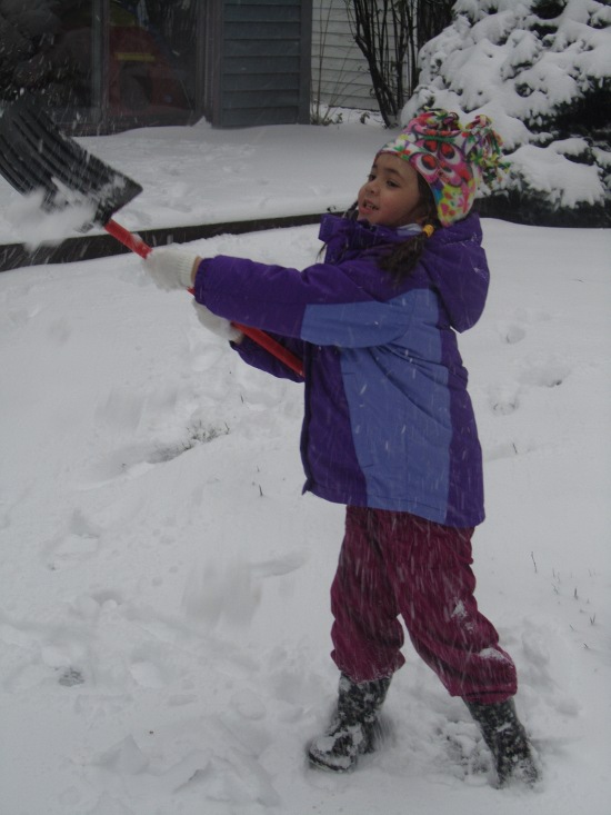 Learning how to shovel snow with her very own special little snow shovel