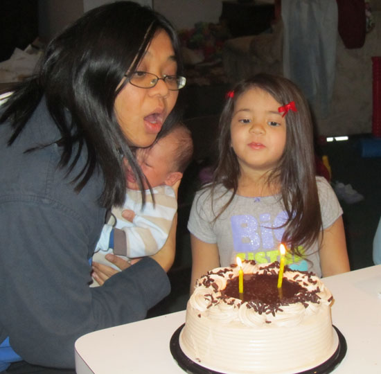 Yaya helps Mama blow out the candles