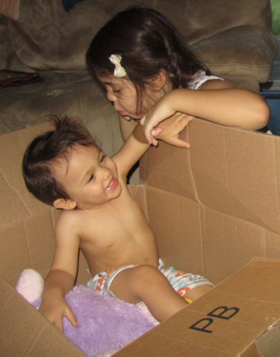Blowing on Adik while he tries to hide in a box