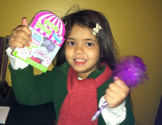 Showing off her presents from Melissa and Maddie