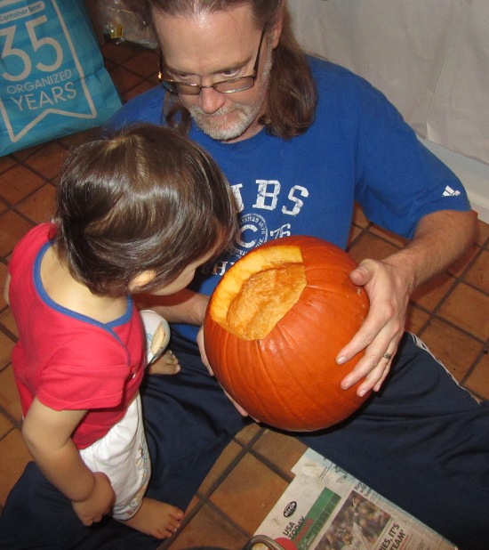 Adik inspects the now emptied out pumpkin