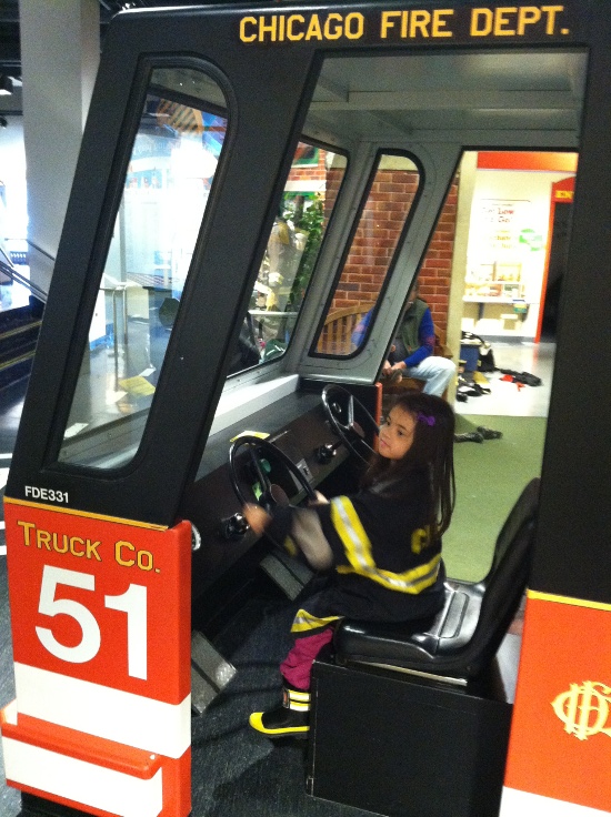 Firefighter Yaya drives the truck (and leans heavily on the siren!)