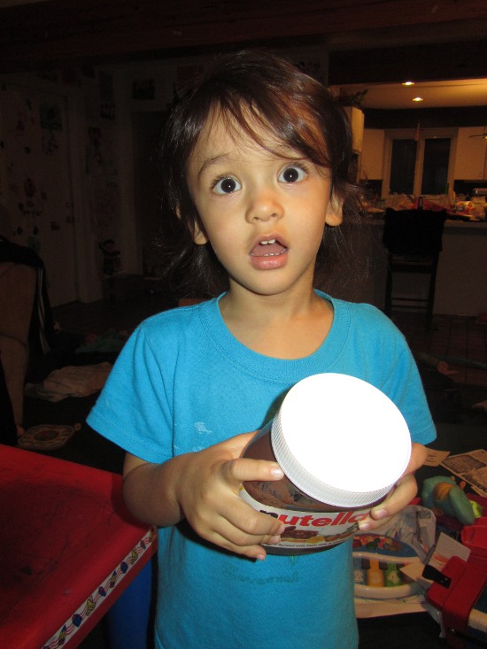 Adik loves the Nutella jar!