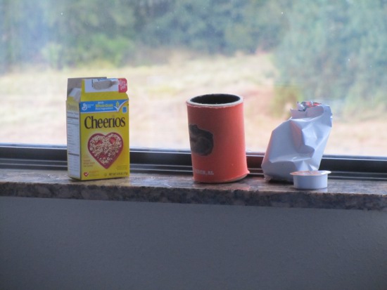 Cheerio box, huggy, Cheerio bag and single-serve peanut butter container on the window sill