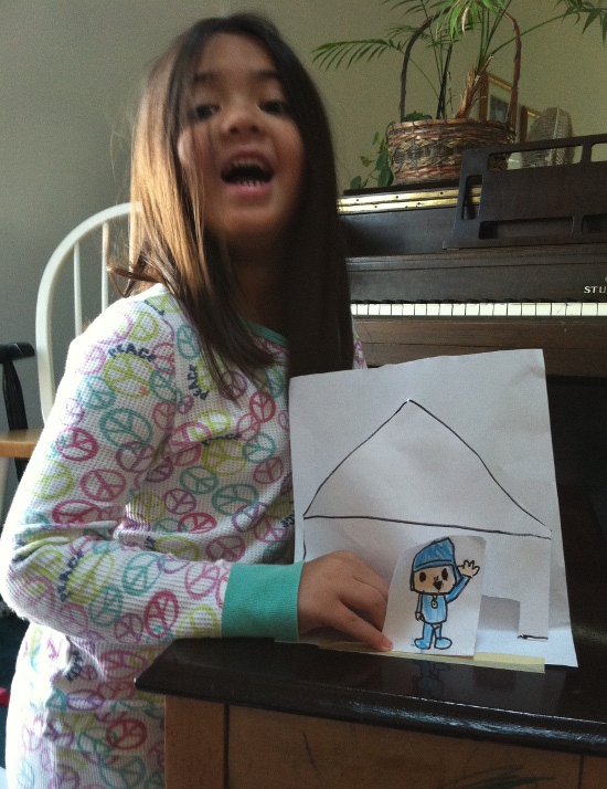 Proudly showing off her "paper mini" Pocoyo