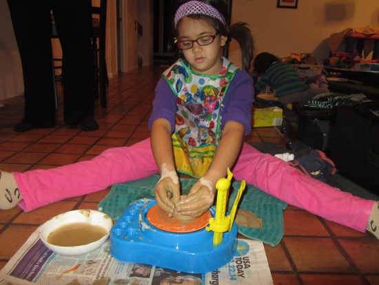 Trying out the pottery wheel and getting nice and messy