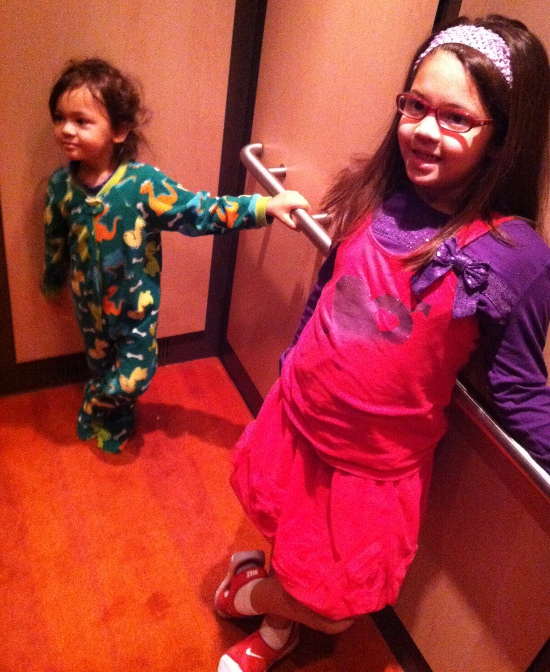 Both kids do the elevator stance on their way to breakfast