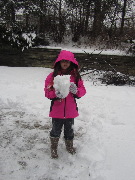 Yaya and a large and lopsided snowball