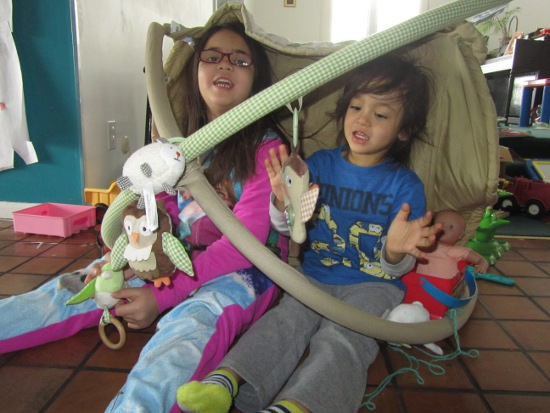 Note the baby doll in her infant car seat next to Adik