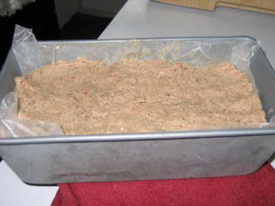 Raw mixture of ground lamb and spices in a loaf pan