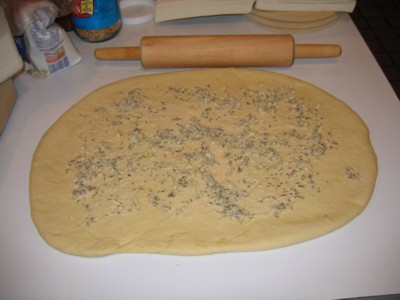 Savory herbs spreaded on the dough