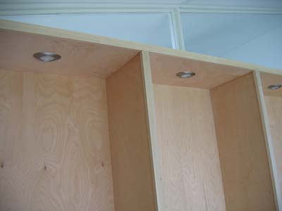 Recessed lights at the top of the shelves