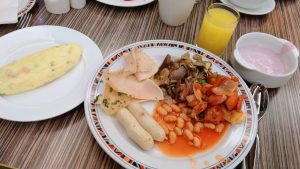 Omelette, yogurt, orange juice and all the stuff on the plate in the centre