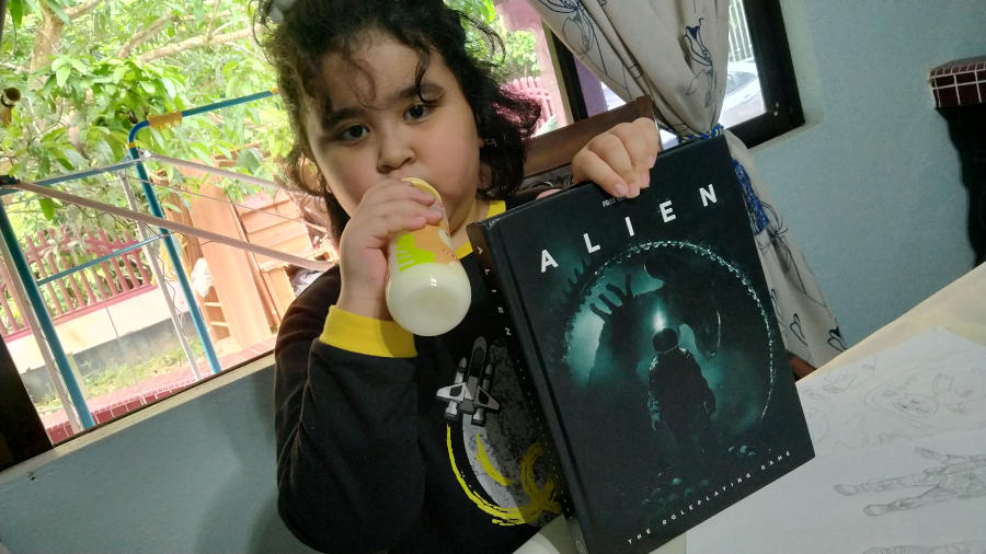 Anya with Alien RPG rulebook