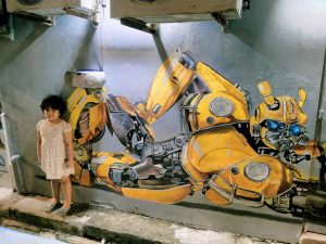 Irfan at the mural of the Autobot Bumblebee