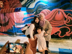 Ain, Cik Ma and Anya at the mural